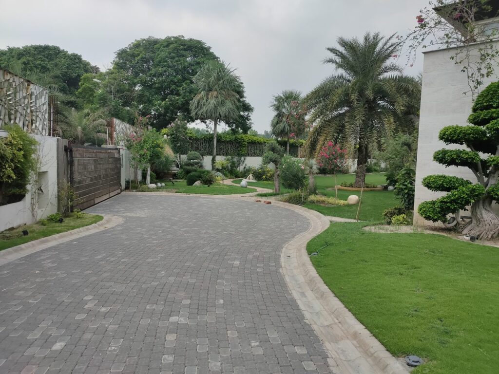 "Commercial-style landscape for US Apparel House with structured lawn and garden beds"