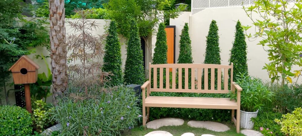 "Symmetrical planting and historic charm in Classical Garden landscaping"