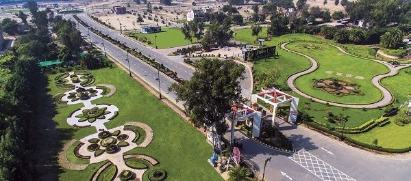 Commercial landscape execution at Palm City Lahore featuring elegant garden design